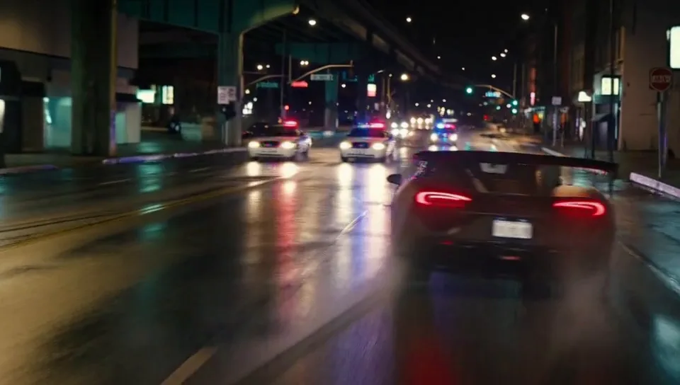 First frame of the clip: Sports car and police chase
